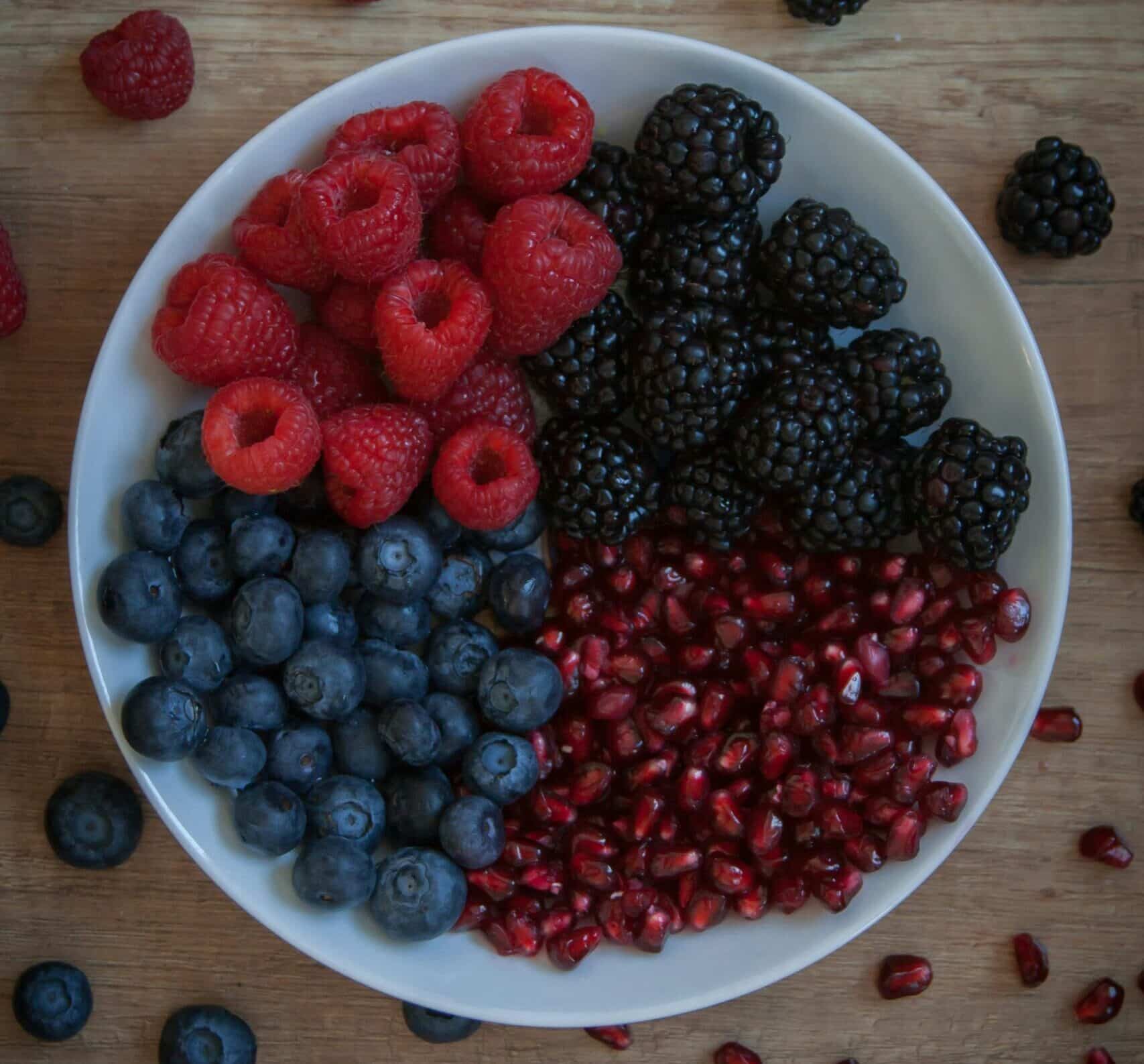blueberries, red berries on a bowl