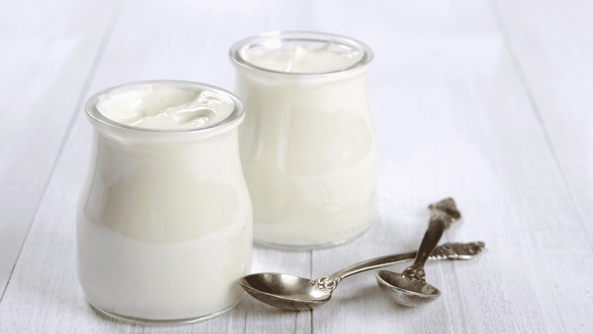 Creamy plain yogurt in a glass bottle with fresh, natural texture