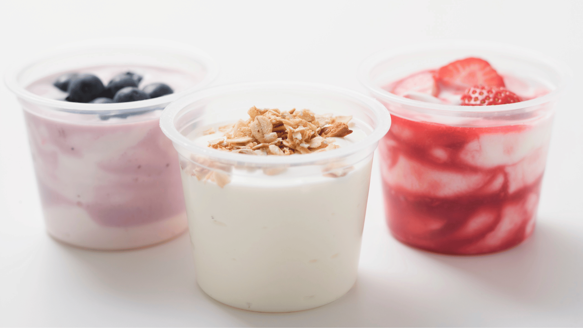Assorted flavored yogurts in colorful cups showcasing fruity flavors