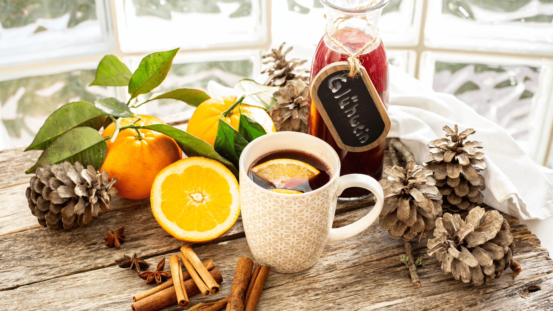 Close-up shot of hot Glühwein being poured into a glass mug, releasing steam and warm holiday aromas.