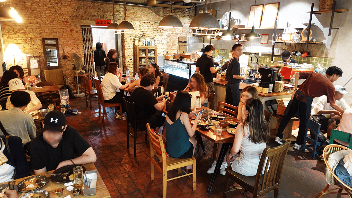Cozy Peranakan-style interior of The Daily Fix Café Melaka, featuring vintage tiles, wooden furniture, and a warm, heritage-inspired ambience.