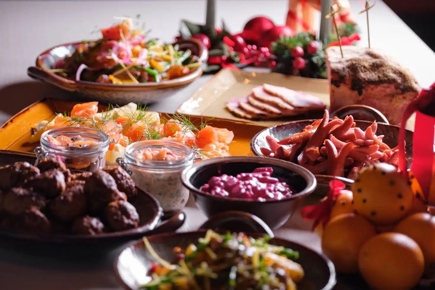 A traditional Swedish Julbord Christmas buffet filled with meatballs, seafood, ham, and cheeses.